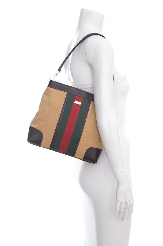 Women Gucci Sylvie bags featuring the signature web stripeGucci Tan Web Canvas Shoulder Handbag