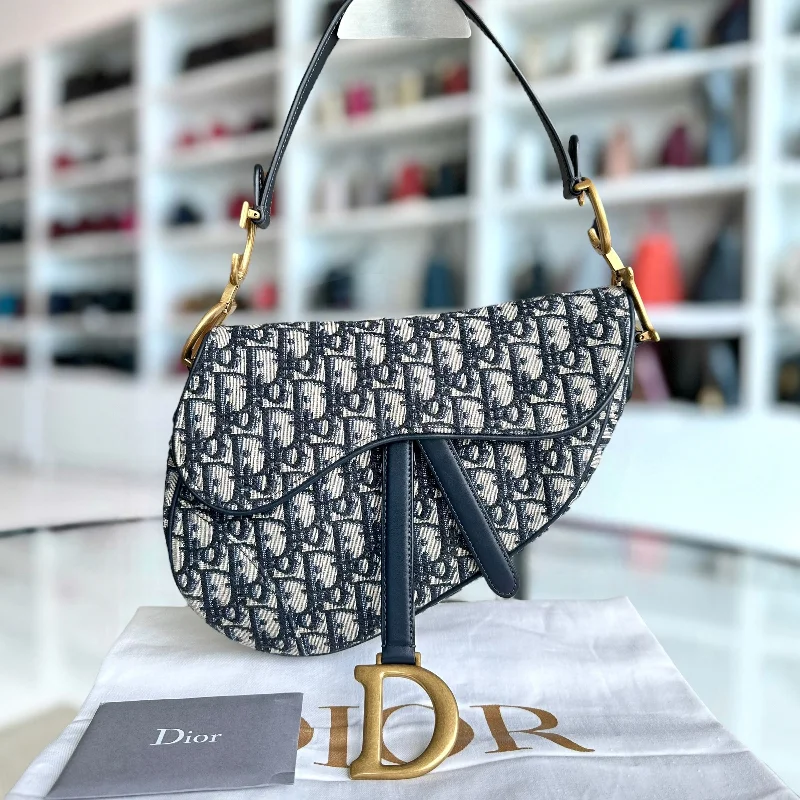 Christian Dior handbags with a snap - button closure and a decorative buckleDior Saddle Medium - Oblique Canvas Dark Blue Aged Gold Hardware